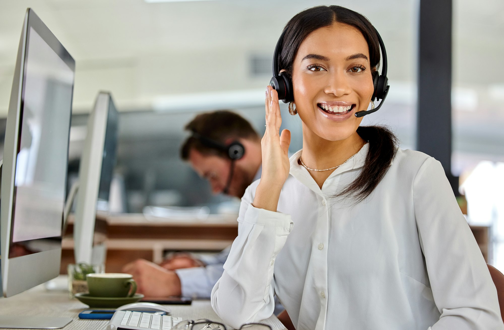 How are you today. Shot of a beautiful young businesswoman working in a call center.